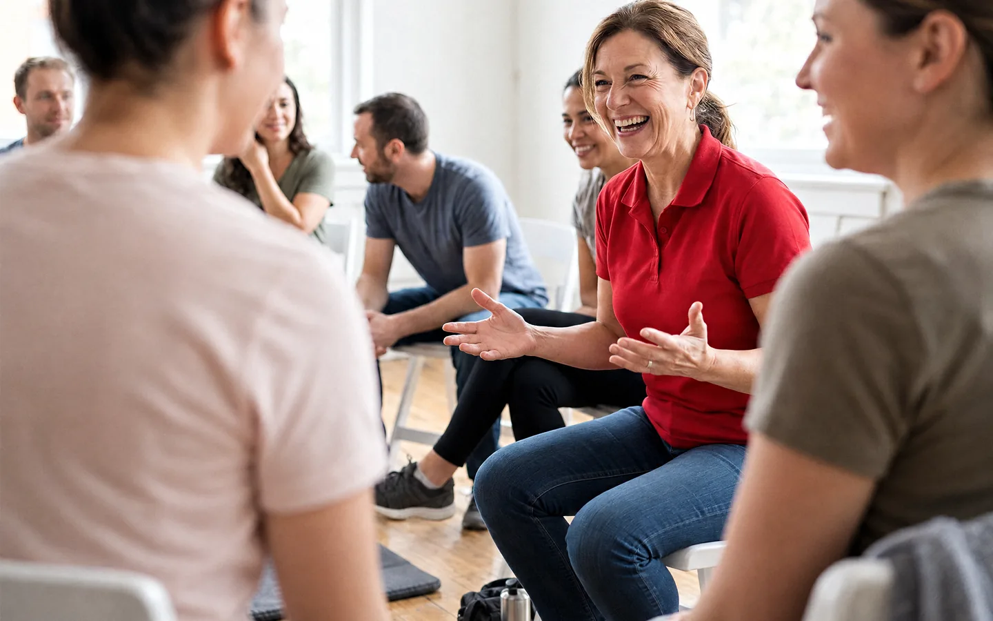 An instructor talking with a group seated in a circle